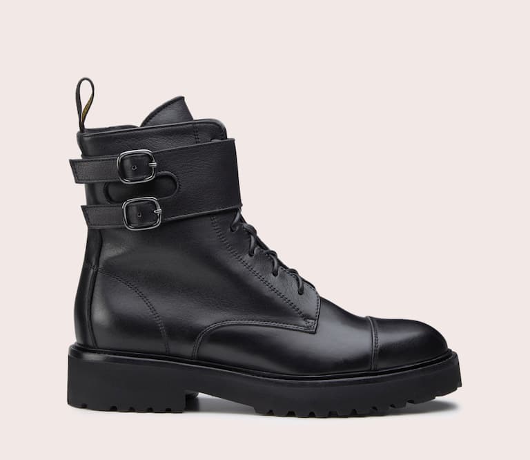 Doucal's. Black leather combat boot, with double monk strap at the ankle. Ultra-light rubber sole in matching colour. Made in Italy.